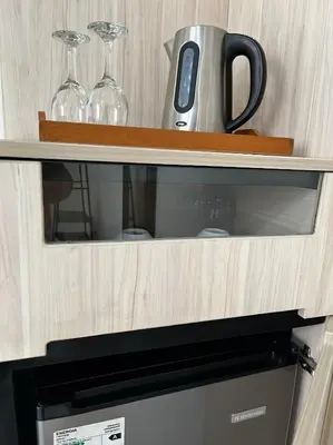 a shelf above a microwave with two wine glasses at Residencial Mar Caribe in Lima