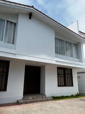 a white house with a garage at Residencial Mar Caribe in Lima