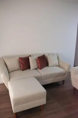 a living room with a white couch with pillows at Departamento de Estreno Lima Miraflores in Lima