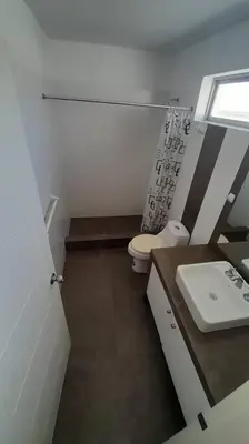 a small bathroom with a toilet and a sink at Gaviotas de Paracas in Paracas