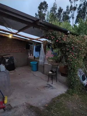 a pergola with a bunch of flowers on it at Casa de Campo Apu San Isidro in Urubamba