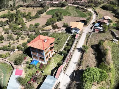 an aerial view of a house with a train at Casa de Campo Apu San Isidro in Urubamba