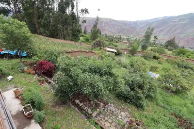 a view of a hill with a train on the tracks at Casa de Campo Apu San Isidro in Urubamba