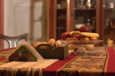 a table with a plate of food on a table at Beraja Family Hostel in Lima