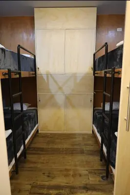 a room with two bunk beds and a door at Casa sabina hostel in Lima