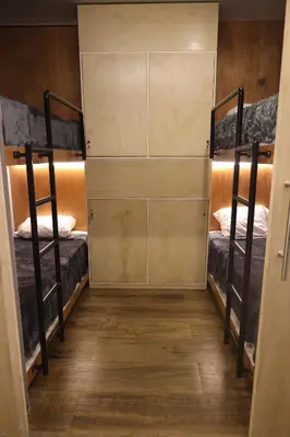 a room with two bunk beds and a wooden floor at Casa sabina hostel in Lima