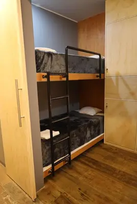 a room with two bunk beds and a closet at Casa sabina hostel in Lima