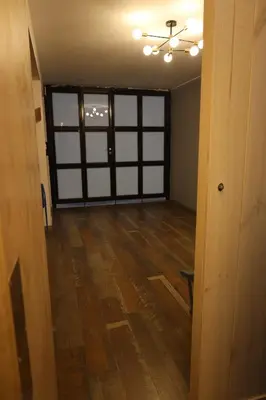 an empty room with a door and wooden floors at Casa sabina hostel in Lima