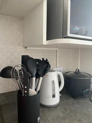 a kitchen counter with utensils and a coffee pot at e-t*| Apartamento frente al mar in Cerro Azul