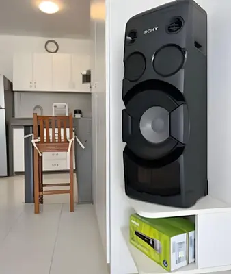 a computer monitor hanging on a wall next to a kitchen at e-t*| Apartamento frente al mar in Cerro Azul