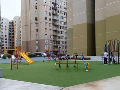 a playground in a city with children playing on it at Amplio Departamento amoblado, Condominio Parques de la Huaca - San Miguel in Lima