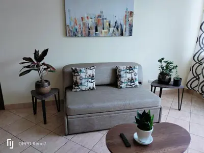 a living room with a couch and two tables with plants at Warmisitay Mini departamento in Lima