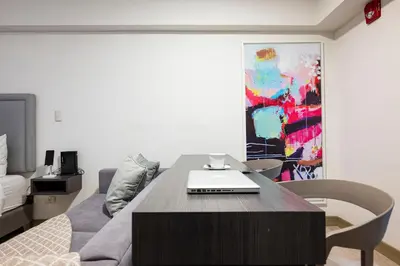 a room with a table with a laptop on it at Connect Studios by Vibrant in Lima