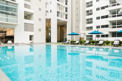 a swimming pool in a building with blue umbrellas at Luxury Apartments Moon Suites Top in Lima