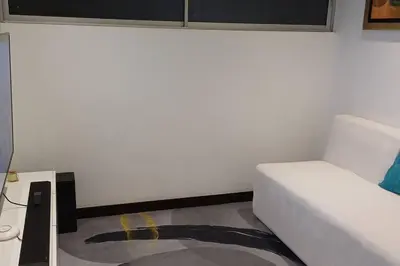 a bedroom with a white bed and a table at Luxury Apartments Moon Suites Top in Lima