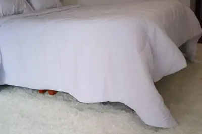 a white bed with white sheets on a white carpet at Luxury Apartments Moon Suites Top in Lima