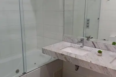 a bathroom with a sink and a shower at Luxury Apartments Moon Suites Top in Lima