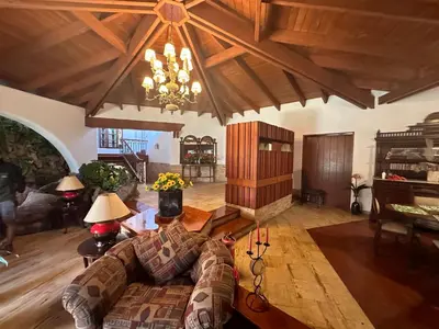 a living room with a couch and a piano at Casa de Campo Condominio El Pueblo-Santa Clara,Ate in Lima