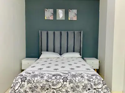 a bed with a black and white comforter in a bedroom at Paloma House in Lima