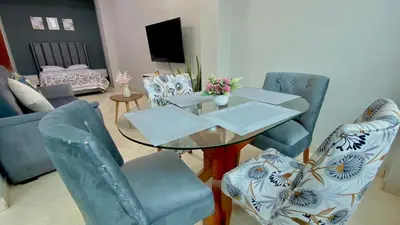 a living room with a glass table and chairs at Paloma House in Lima
