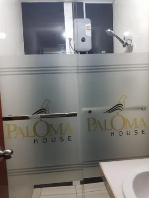 a glass door in a bathroom with a bathroom house at Paloma House in Lima