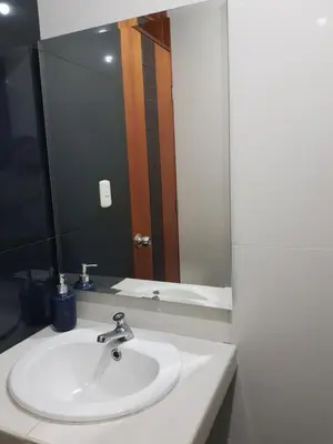 a bathroom with a sink and a large mirror at Paloma House in Lima