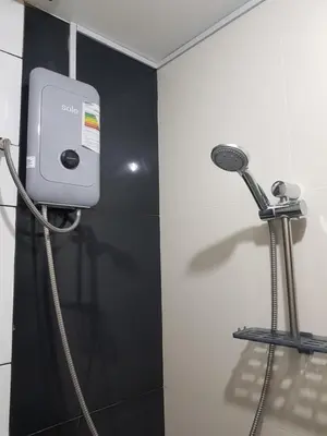 a shower in a bathroom with a shower head at Paloma House in Lima