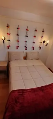 a bedroom with a large bed with sails on the wall at Panoramic Cusco in Cusco