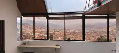a room with a window with a view of a city at Panoramic Cusco in Cusco