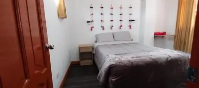 a small room with a bed and hockey sticks on the wall at Panoramic Cusco in Cusco