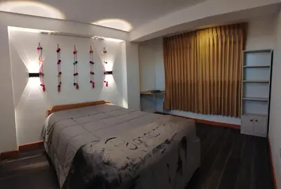 a bedroom with a bed with baseball bats on the wall at Panoramic Cusco in Cusco