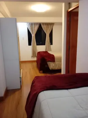 a hotel room with two beds and a window at Panoramic Cusco in Cusco