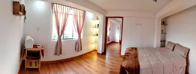 a bedroom with a large bed and a window at Panoramic Cusco in Cusco