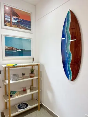 a surfboard hanging on a wall in a room at Condominio Ocean reef in San Bartolo