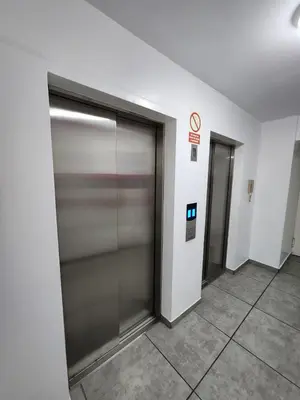 an elevator lobby with two doors in a building at Entire Apartment 20 min from airport - Cozy and Secure in Lima