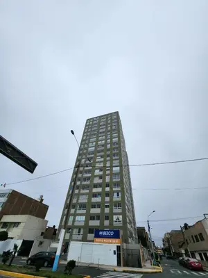 a tall building with a sign on the side of it at Entire Apartment 20 min from airport - Cozy and Secure in Lima