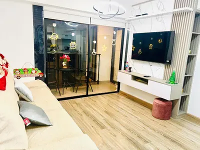 a living room with a couch and a flat screen tv at Pacific apartamento Miraflores in Lima