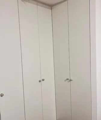 a row of white cabinets in a room at Pacific apartamento Miraflores in Lima