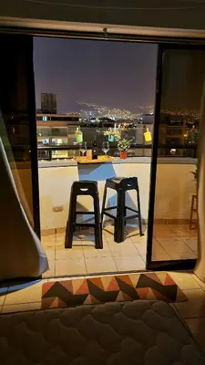 a view of a balcony with two chairs and a table at Habitación con Baño privado en Departamento Compartido in Lima