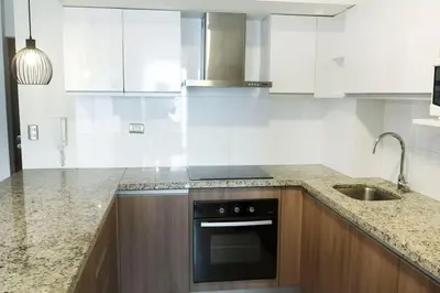 a kitchen with white cabinets and a black oven at Comfort and Space 3bed and 2 and haf bath centric location in Lima