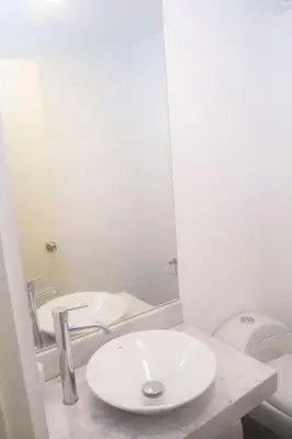 a white bathroom with a sink and a toilet at Comfort and Space 3bed and 2 and haf bath centric location in Lima