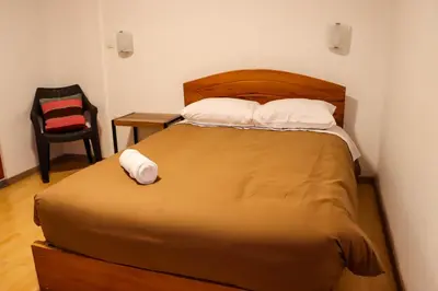 a bed with two pillows on it in a room at Andes House Cusco in Cusco