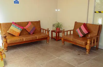 two brown leather couches with colorful pillows on them at Andes House Cusco in Cusco