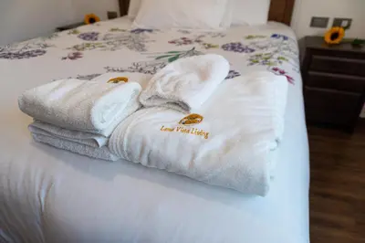 a pair of towels sitting on top of a bed at Lama Vista Living 201 in Cusco