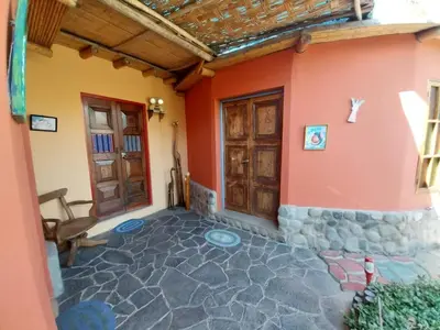 an outside view of a house with a patio at Soy y Luna- ECOALBERGUE RETABLOS PERU in Lunahuaná