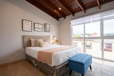 a bedroom with a bed and a large window at Private Residences by Vibrant in Lima