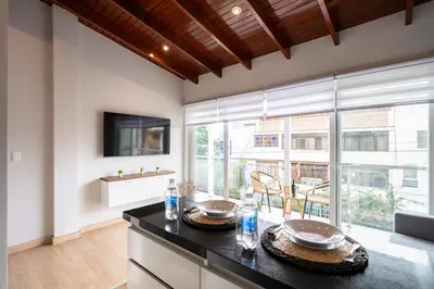 a kitchen with a large window and a television at Private Residences by Vibrant in Lima