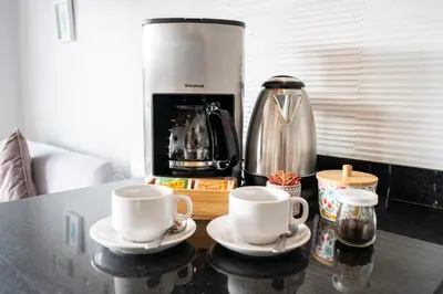 two coffee cups on a table with a coffee maker at Private Residences by Vibrant in Lima