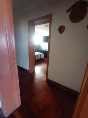 a hallway with a room with a bed and a door at Eli Travelers House in Lima