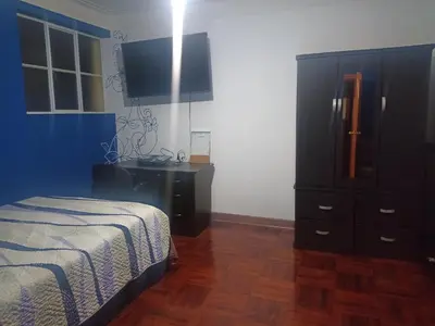 a bedroom with a bed and a dresser at Eli Travelers House in Lima